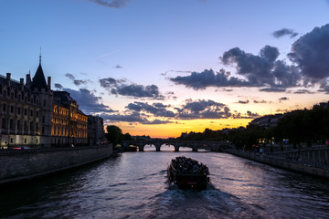 Sunset over Conciergerie and Pont Neuf bridge at Golden hour - Paris, France.