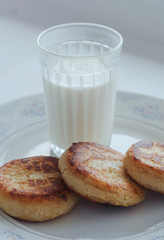 breakfast, a glass of milk and curd cheesecakes