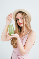 Girl drinks a healthy green drink with Basil seeds