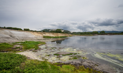 Hot water lake and mud field in Uzon caldera. Kronotsky Nature Reserve in Russian far east, Kamchatka peninsula. Strongly protected environment . Access here is only by helicopter.