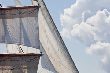 Obraz premium Barquentine yacht sails rigging clouds background