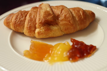 Fresh croissant, lemon curd and marmelade