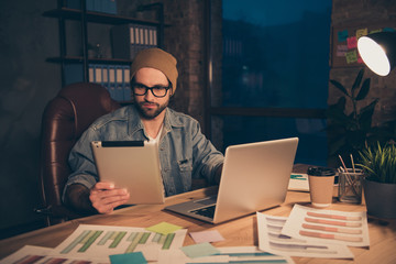 Photo of confident guy work at dark day time dressed in casual outfit sit modern office chair