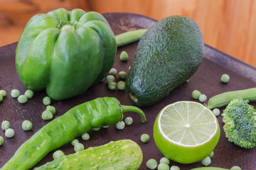 A set of green vegetables: cucumbers, peppers, peas, avocados, broccoli
