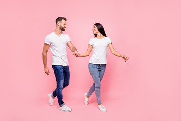 Full length body size photo of couple walking streets of town they have just arrived in while isolated with pastel background