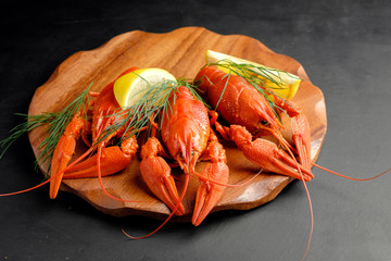 lobster with lemon lime and green dill on black background top view