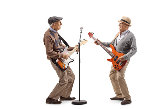 Two Elderly Men Having A Jam Session With Electric Guitars