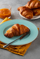 Delicious breakfast with fresh croissants and jam served with butter.