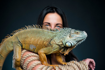 sexy woman in underwear in studio with green iguana