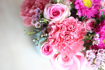pink roses and flower bouquet in blue mason jar