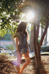 girl with sunshine in trees