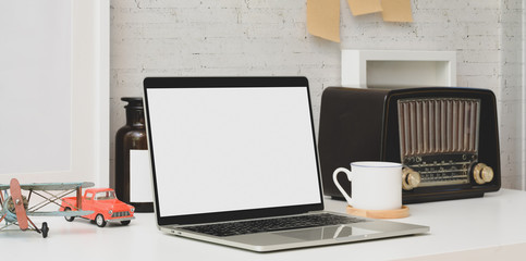 Blank screen laptop computer with vintage retro radio