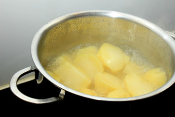 Boiling potatoes in a pan