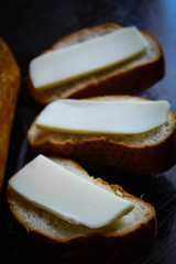 Three fresh sandwiches with melted cheese in a glass plate