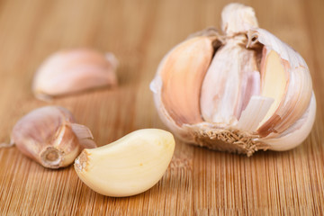 Soft focus. Cloves of garlic on a wooden background.