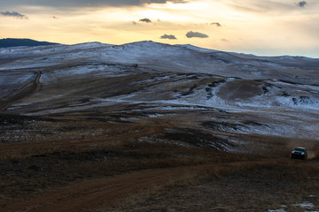 Dried grass field on hill in Siberia, Russia, hill at sunset time