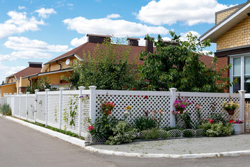 white mesh fence of the front garden in a suburban village