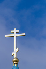 The dome of the Orthodox Church with a golden cross against the sky.