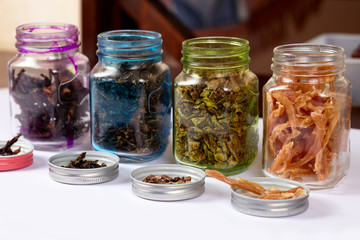 The row of color pots with some dehydrated organic products. Homemade meat and chicken dog treats,...