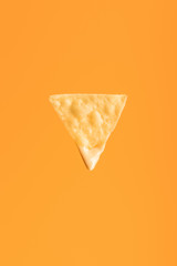 top view of crispy nacho isolated on orange, Mexican cuisine