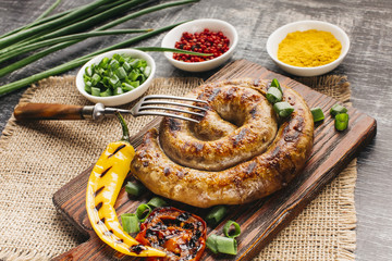 Close-up of grilled snail sausage on cutting board