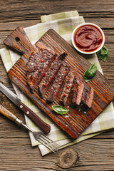 Close-up of fried steak with sauce on wooden table