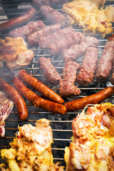 Grilling chicken and pork meat on the grill.