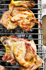 Grilling chicken and pork meat on the grill.