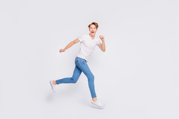 Full size photo of jumping high guy speed race participant wear casual outfit isolated white background