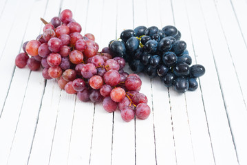 red grapes variation on white wooden