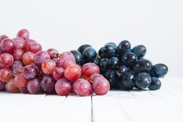 red grapes variation on white wooden