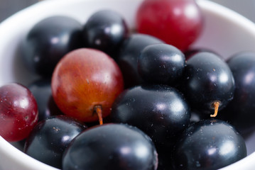 red grapes on black wood table
