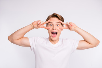 Close-up portrait of his he nice cute attractive cheerful cheery positive optimistic crazy guy showing double v-sign near eyes isolated over light white pastel background