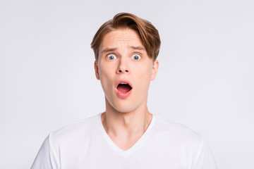 Close-up portrait of his he nice cute attractive worried scared guy expressing fear opened mouth isolated over light white pastel background