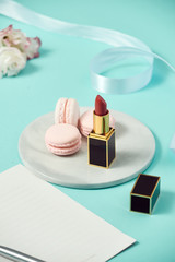 Composition with gift box and set of decorative cosmetics on blue background