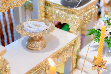 holy thread  roll on gold tray with pedestal. amulet in buddhist religion ceremony. image for objects, background, illustration and copy space.