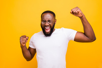 Photo of emotional joyful black man unable to hide his emotions inside while isolated with vivid...
