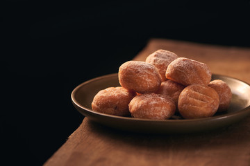 Small donuts with powdered sugar selective focus