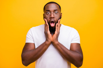 Photo of terrified shocked black man having been negatively surprised while isolated with vivid...