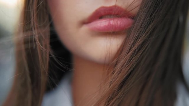 Beauty aesthetic innovation. Full lips. Young woman. Flowy hair.