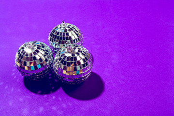 disco ball shines on purple background close up
