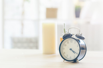 Naklejka premium Morning sun. Alarm clock on a beautiful background
