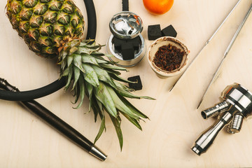 Parts of hookah and fruits on wooden background