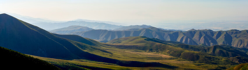 Panorama of a mountain valley in summer, aerial view. Fairytale sunset over the mountain peaks, amazing nature, summer in the mountains. Travel, tourism. beautiful background picture of nature