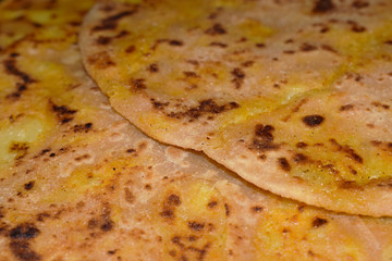 Alu Paratha in Plate with Black Background
