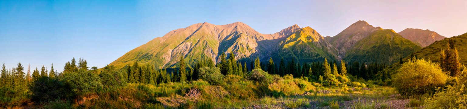 Panorama of a mountain valley in summer, aerial view. Fairytale sunset over the mountain peaks, amazing nature, summer in the mountains. Travel, tourism. beautiful background picture of nature