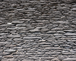 very old wall made of flat natural stones in ireland