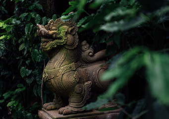 The ancient Singha statue in the forest