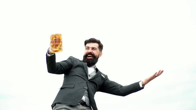 Man holding mug of beer. Happy brewer holding glass with beer. Drink beer. Senior man drinking beer with surprise face.