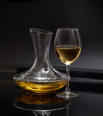 A glass full of wine and wine decanters